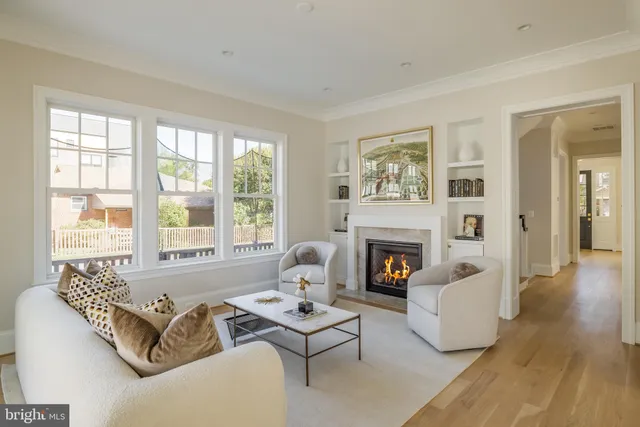 a living room with furniture large window and fireplace