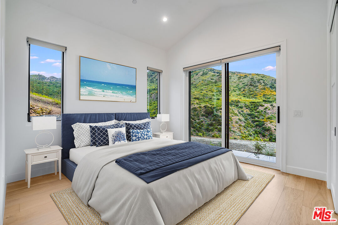 26575 Ocean View Drive Malibu, CA 90265 - Photo 13 of 39 a bedroom with a large bed and a window