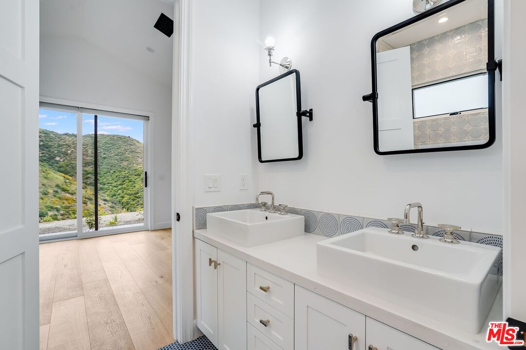 26575 Ocean View Drive Malibu, CA 90265 - Photo 15 of 39 a bathroom with 2 sink and a mirror
