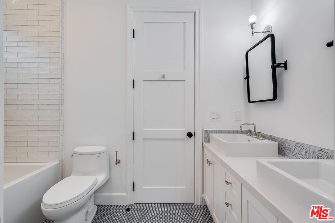 26575 Ocean View Drive Malibu, CA 90265 - Photo 17 of 39 a bathroom with a toilet sink vanity tub and mirror
