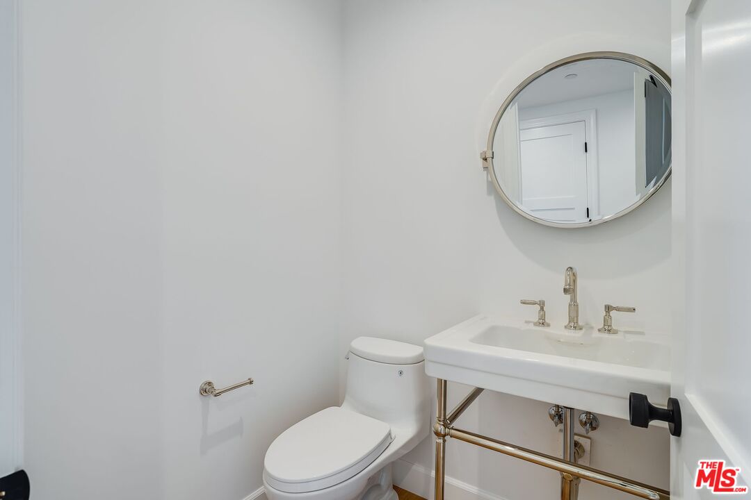26575 Ocean View Drive Malibu, CA 90265 - Photo 20 of 39 a bathroom with a toilet a sink and mirror