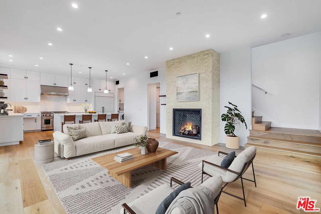 26575 Ocean View Drive Malibu, CA 90265 - Photo 2 of 39 a living room with furniture and a fireplace