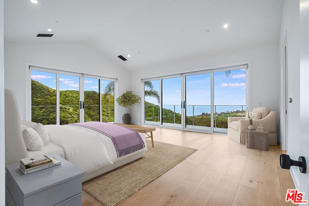 26575 Ocean View Drive Malibu, CA 90265 - Photo 22 of 39 a bed room with a bed and a large window