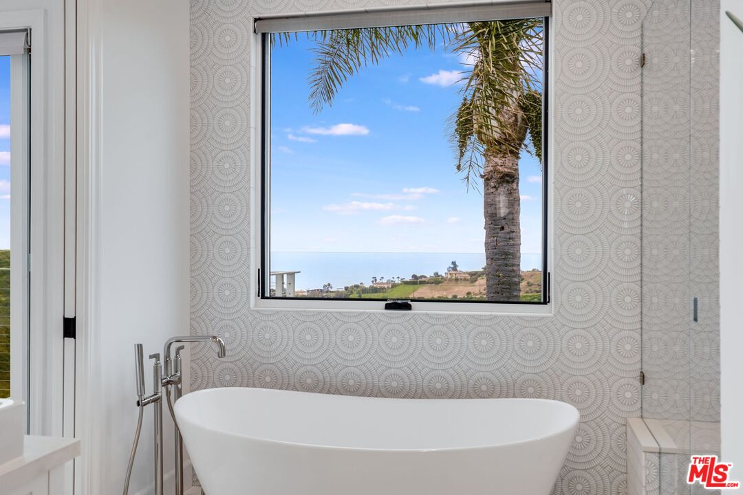 26575 Ocean View Drive Malibu, CA 90265 - Photo 24 of 39 a bath tub sitting next to a white toilet and a shower