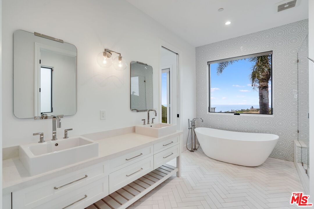 26575 Ocean View Drive Malibu, CA 90265 - Photo 25 of 39 a bathroom with a double vanity sink mirror and bathtub
