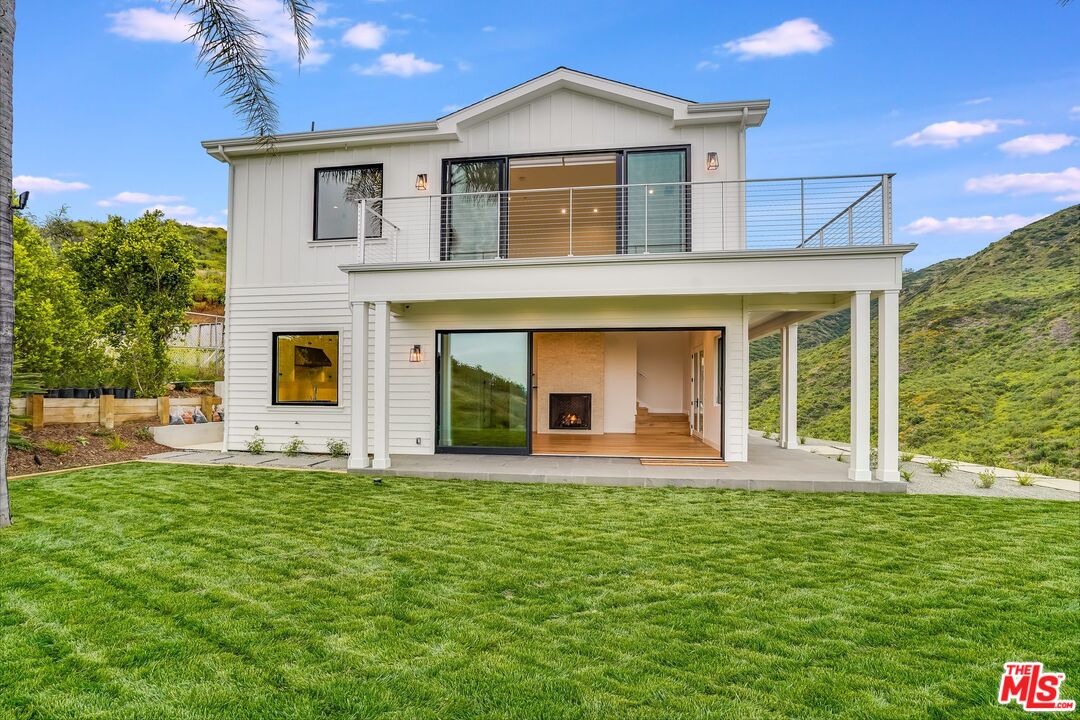 26575 Ocean View Drive Malibu, CA 90265 - Photo 3 of 39 a front view of a house with a yard