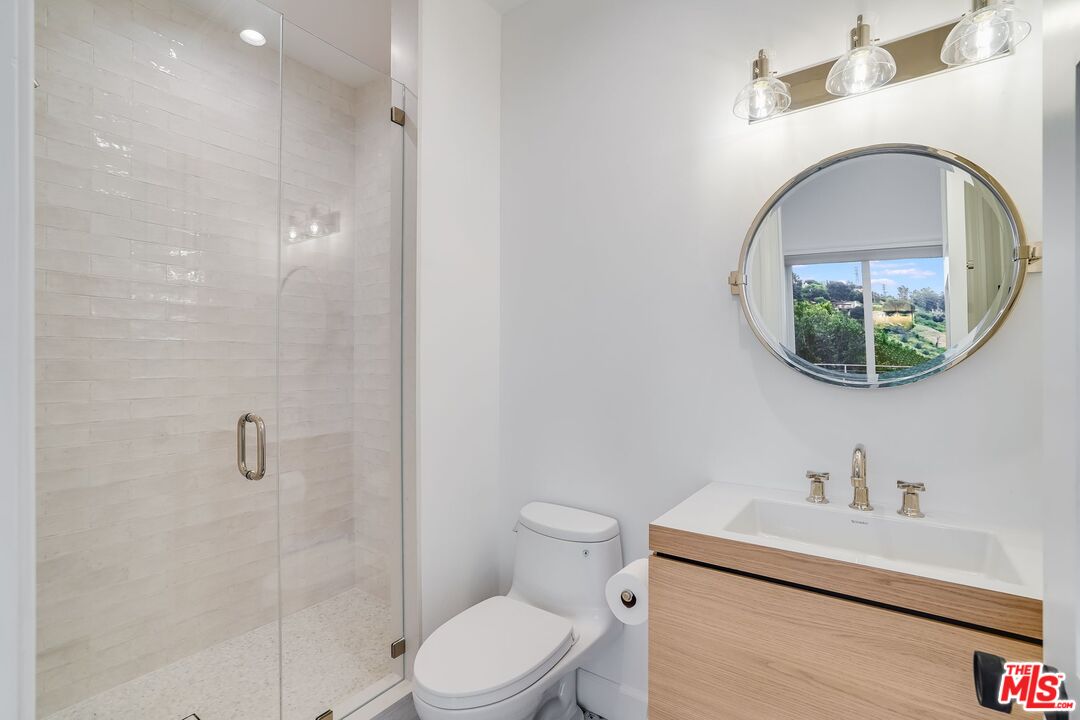 26575 Ocean View Drive Malibu, CA 90265 - Photo 34 of 39 a bathroom with a toilet a sink and mirror