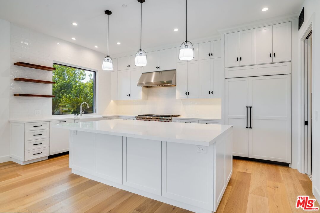 26575 Ocean View Drive Malibu, CA 90265 - Photo 8 of 39 a kitchen with white cabinets and window