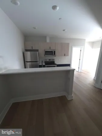 a kitchen with stainless steel appliances a sink stove and cabinets
