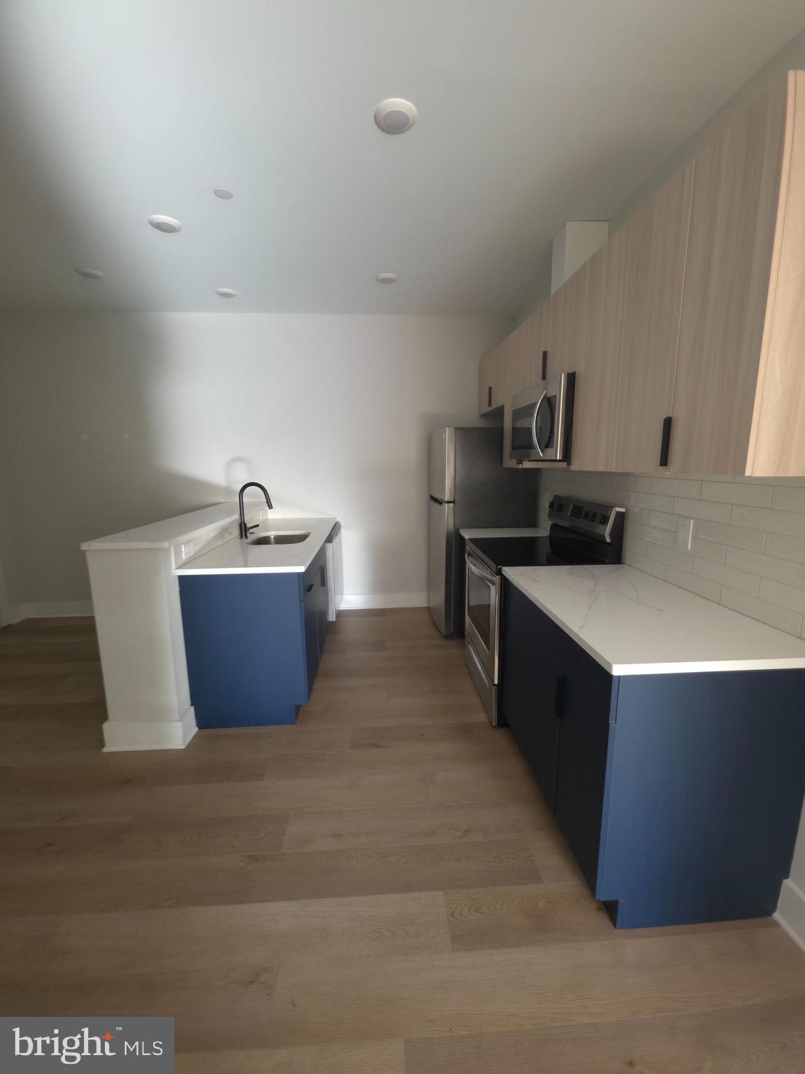 3503 Midvale Avenue, Unit 404 Philadelphia, PA 19129 - Photo 25 of 37 a kitchen with stainless steel appliances a sink stove and cabinets