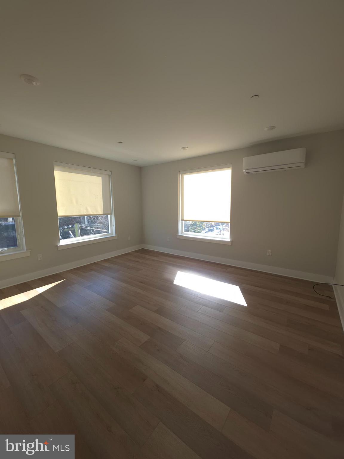 3503 Midvale Avenue, Unit 404 Philadelphia, PA 19129 - Photo 27 of 37 an empty room with wooden floor and windows