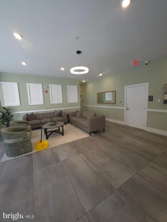 a living room with a table chairs and a window