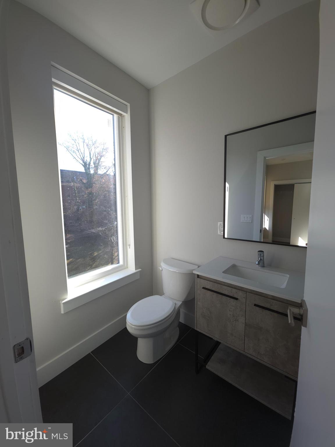 3503 Midvale Avenue, Unit 404 Philadelphia, PA 19129 - Photo 35 of 37 a bathroom with a sink toilet a mirror and window
