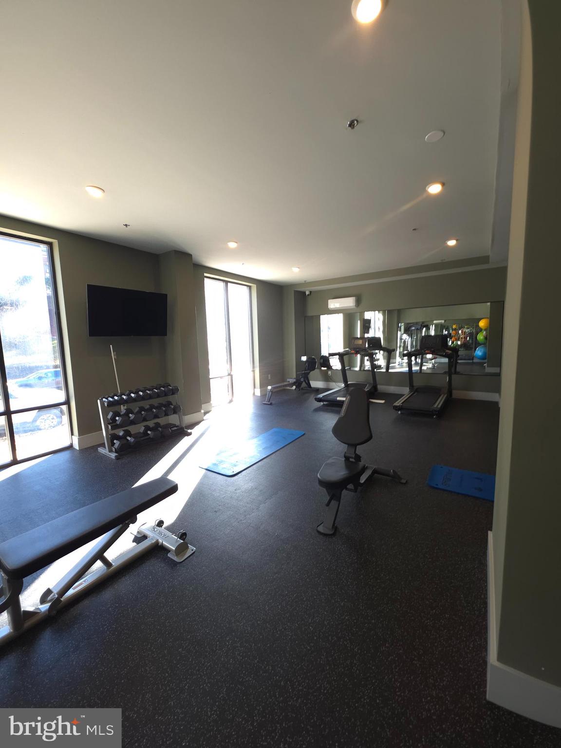 3503 Midvale Avenue, Unit 404 Philadelphia, PA 19129 - Photo 7 of 37 a room with gym equipment and a large window