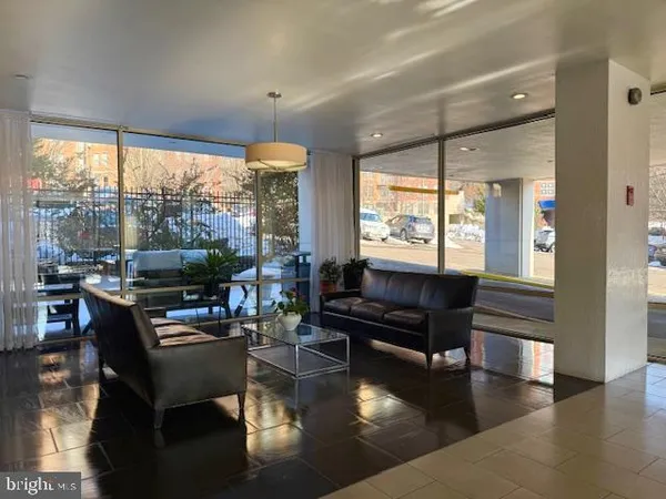 a living room with fireplace furniture and a large window