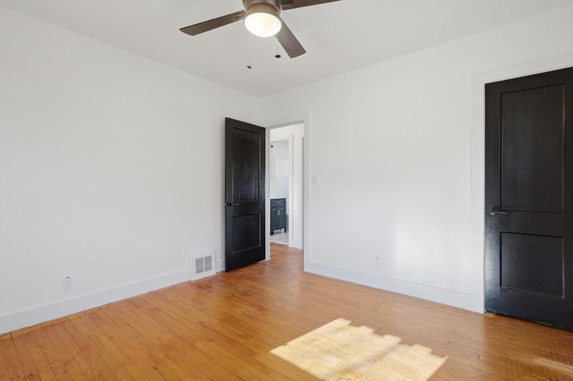 2633 16th Street Moline, IL 61265 - Photo 11 of 26 an empty room with wooden floor closet and windows
