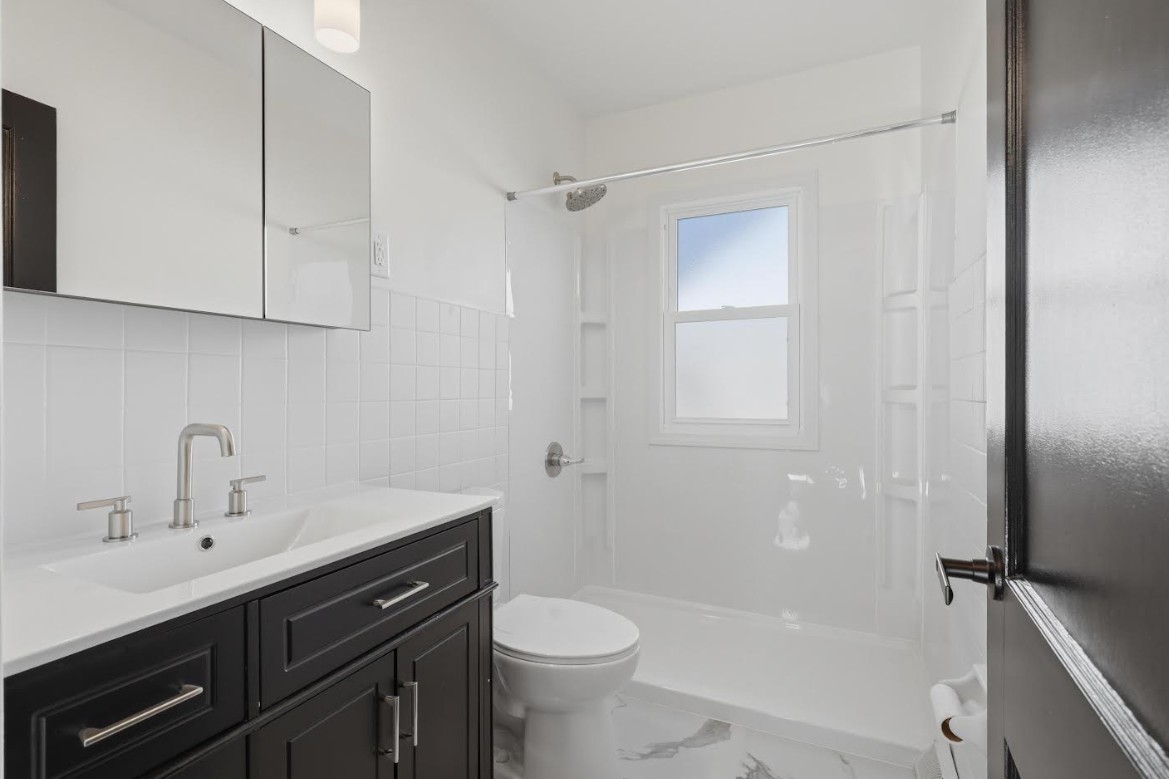 2633 16th Street Moline, IL 61265 - Photo 14 of 26 a bathroom with a sink a toilet and shower