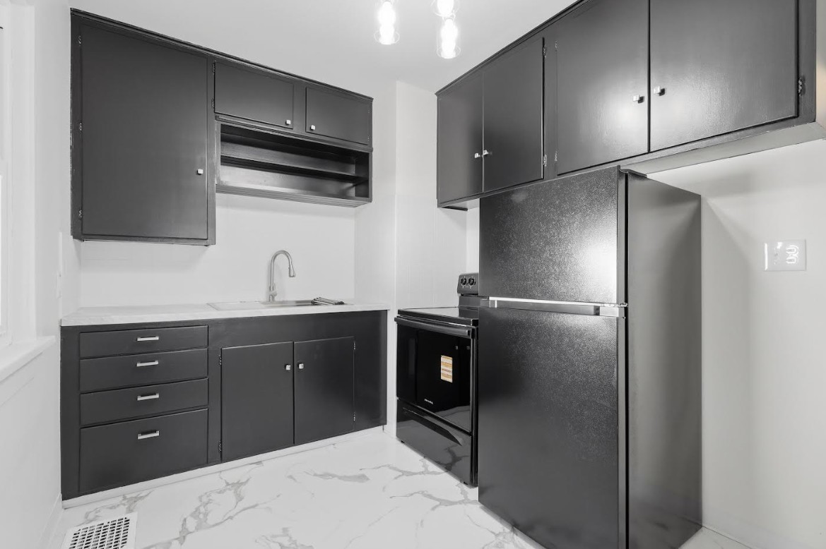 2633 16th Street Moline, IL 61265 - Photo 7 of 26 a kitchen with a refrigerator and a sink