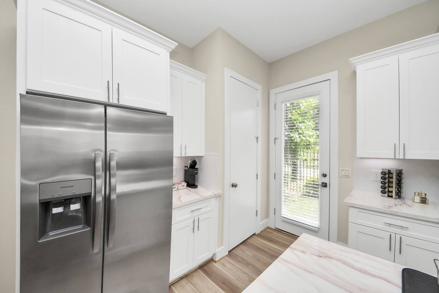 5935 Beall Street, Unit D Houston, TX 77091 - Photo 13 of 50 a kitchen with a refrigerator a sink and cabinets