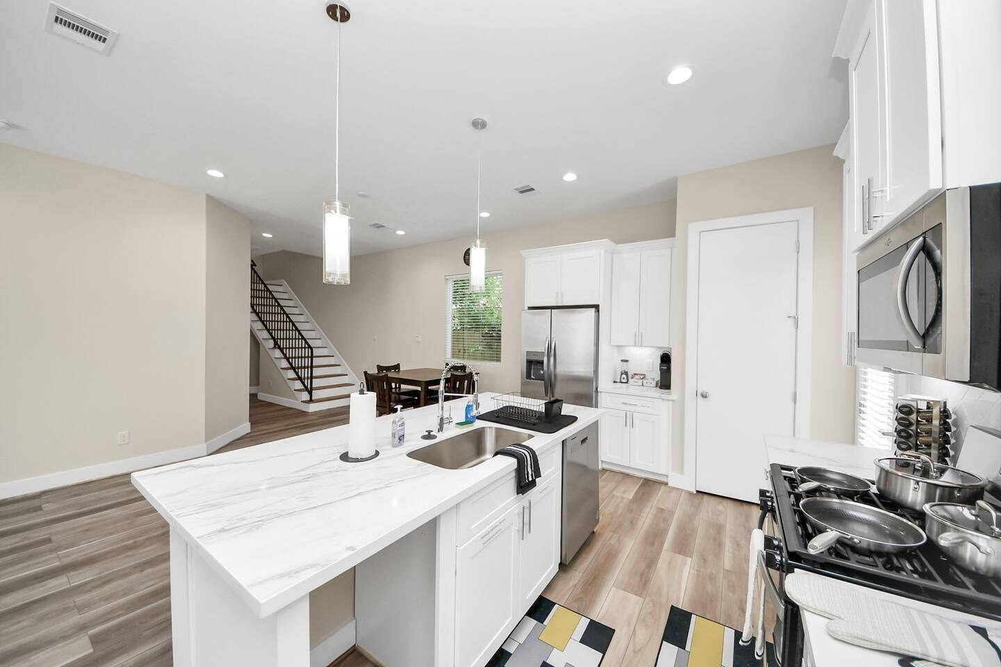 5935 Beall Street, Unit D Houston, TX 77091 - Photo 7 of 50 a kitchen with stainless steel appliances kitchen island granite countertop a sink and cabinets