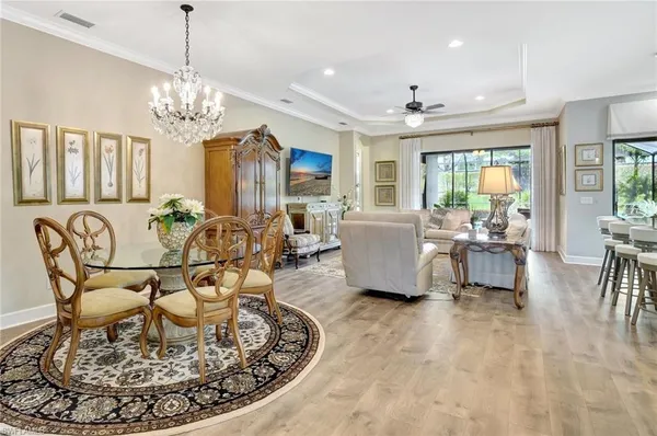 a view of a dining room with furniture and chandelier