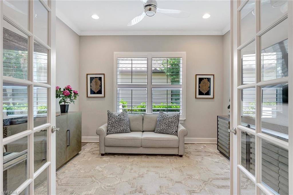 8558 Maggiore Court Naples, FL 34114 - Photo 13 of 50 a living room with furniture and a floor to ceiling window