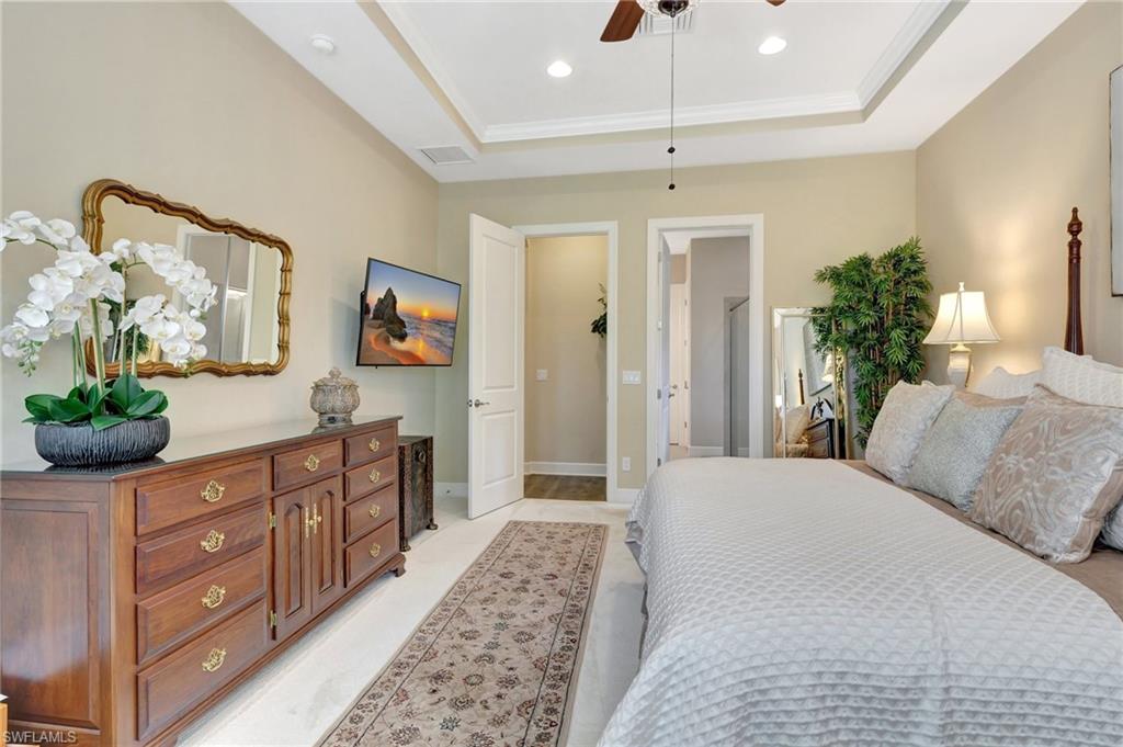 8558 Maggiore Court Naples, FL 34114 - Photo 24 of 50 a bedroom with a bed and a dresser