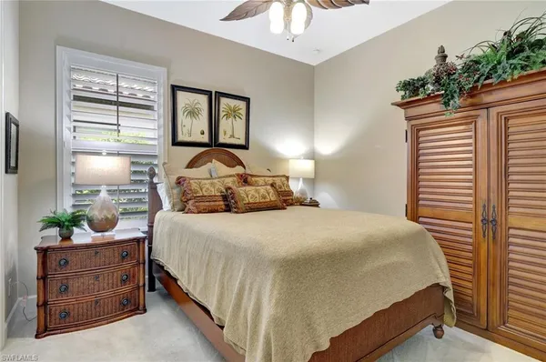 a bedroom with a bed and a television