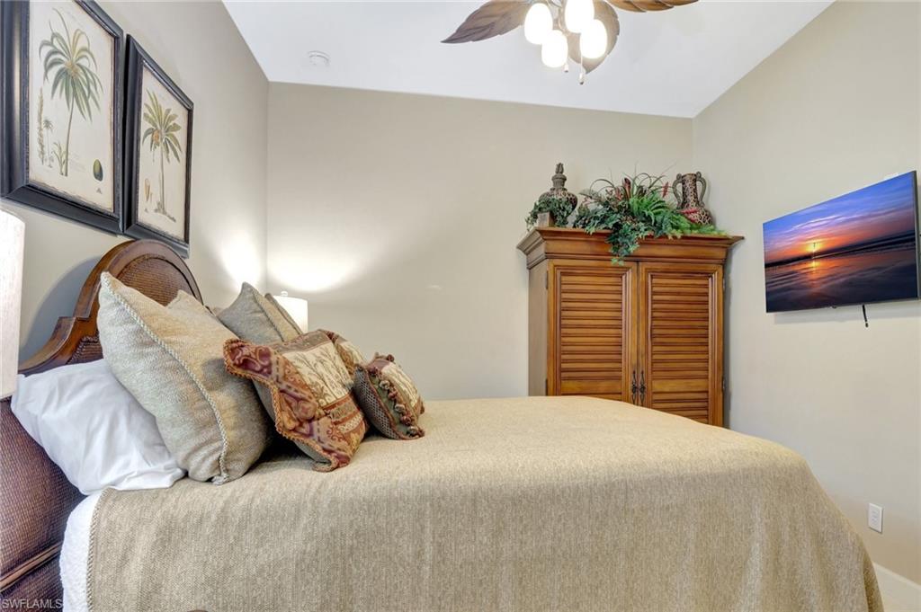 8558 Maggiore Court Naples, FL 34114 - Photo 29 of 50 a bedroom with a bed and a television