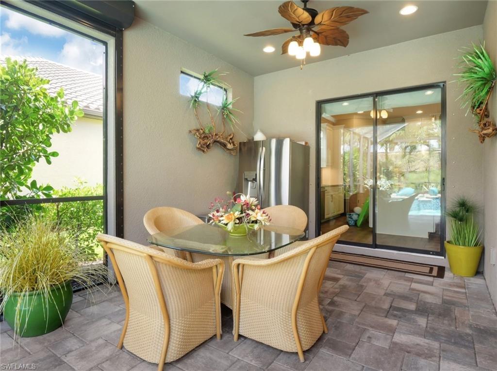 8558 Maggiore Court Naples, FL 34114 - Photo 38 of 50 a dining room with furniture and floor to ceiling windows