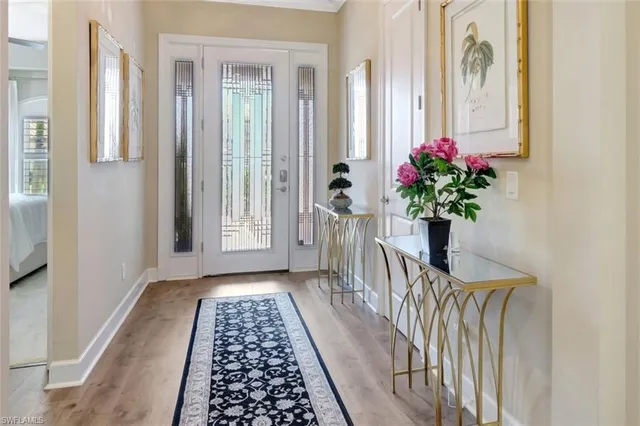 a hallway with a potted plant and a window