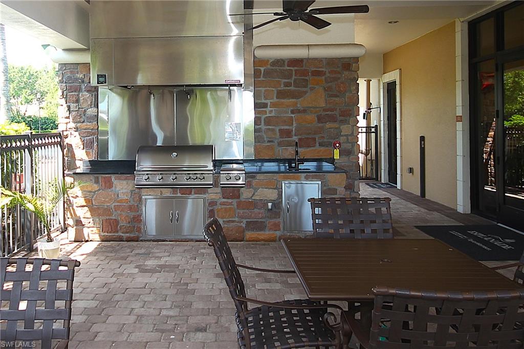 8558 Maggiore Court Naples, FL 34114 - Photo 46 of 50 a kitchen with a sink a stove and cabinets