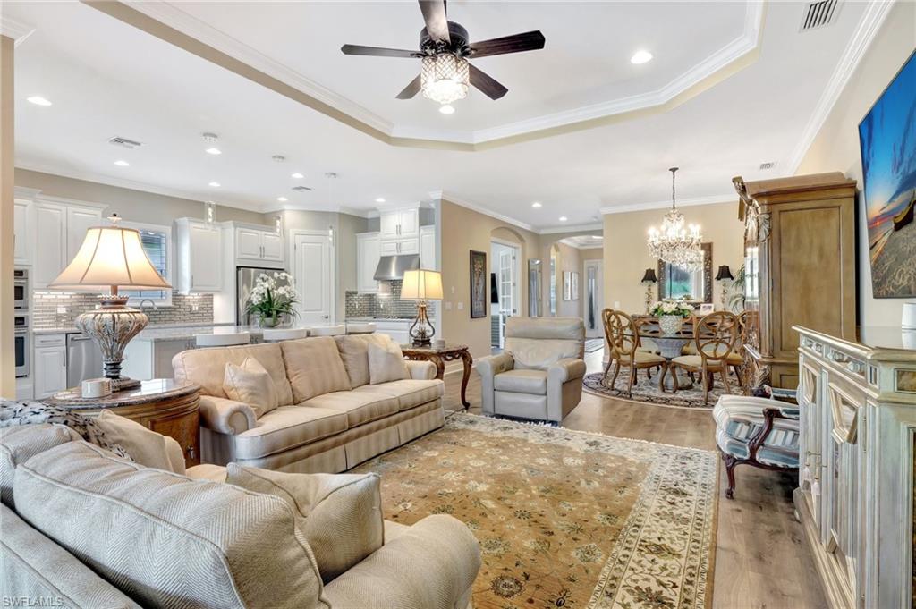 8558 Maggiore Court Naples, FL 34114 - Photo 6 of 50 a living room with furniture kitchen view and a chandelier
