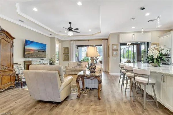 a living room with furniture and a chandelier
