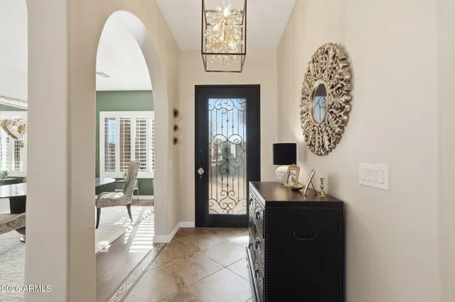 a kitchen with a dining table chairs stainless steel appliances and cabinets