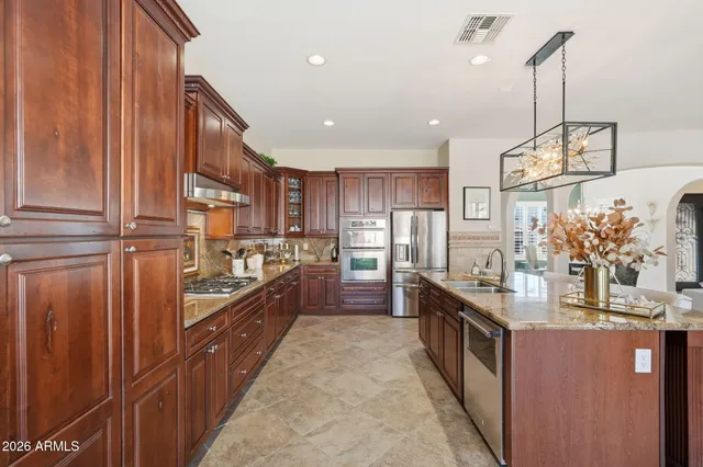 a bed room with a bed and a chandelier