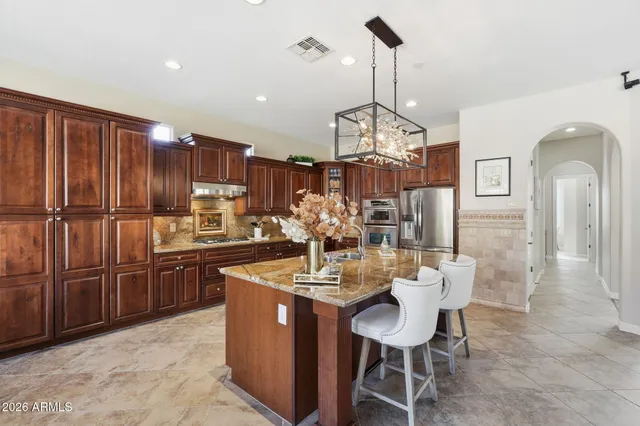 a kitchen with refrigerator cabinets dining table and chairs