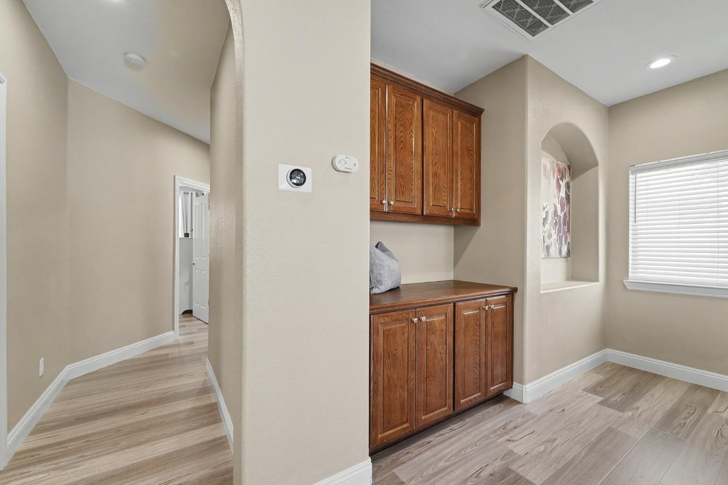 1223 East Springer Drive Turlock, CA 95382 - Photo 24 of 48 a view of a kitchen with wooden floor and cabinets