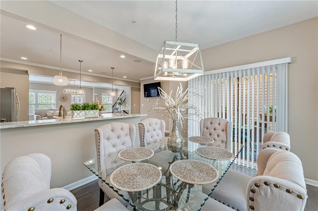 331 Trinity Way Wexford, PA 15090 - Photo 16 of 50 a dining room with furniture a chandelier and wooden floor