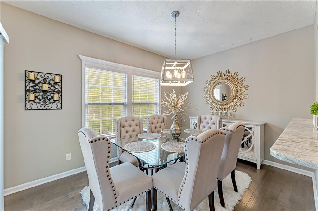 331 Trinity Way Wexford, PA 15090 - Photo 17 of 50 a view of a dining room with furniture a chandelier and wooden floor