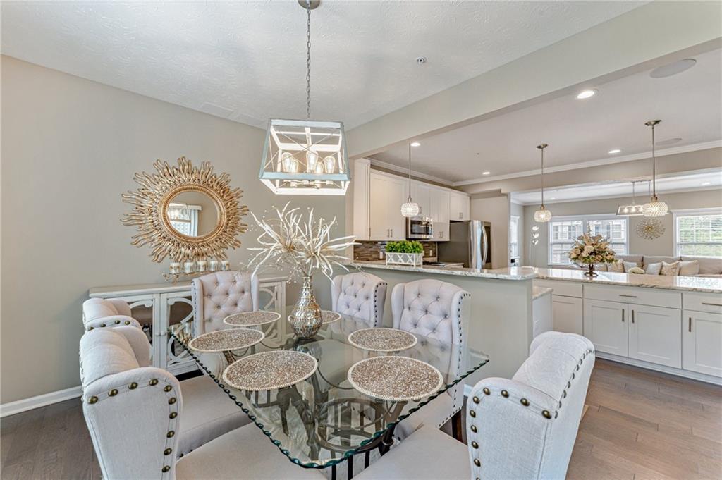 331 Trinity Way Wexford, PA 15090 - Photo 18 of 50 a kitchen with stainless steel appliances granite countertop a dining table chairs and chandelier
