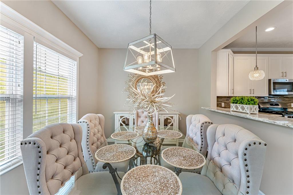 331 Trinity Way Wexford, PA 15090 - Photo 19 of 50 a dining room with furniture a chandelier and a window