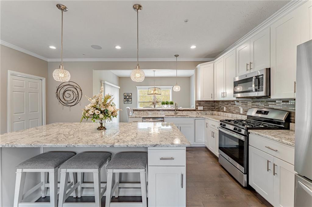 331 Trinity Way Wexford, PA 15090 - Photo 2 of 50 a kitchen with kitchen island granite countertop a stove and a sink