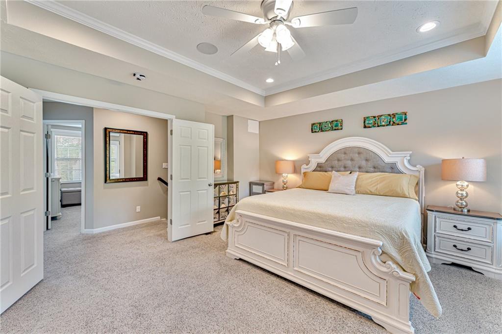 331 Trinity Way Wexford, PA 15090 - Photo 31 of 50 a bedroom with a bed and a chandelier