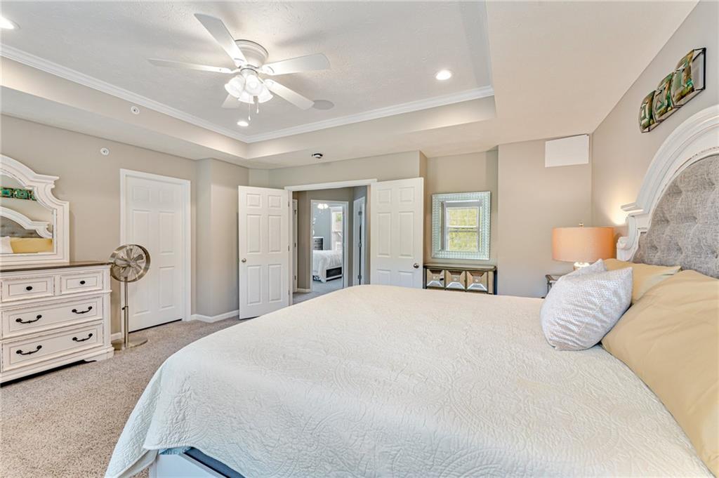 331 Trinity Way Wexford, PA 15090 - Photo 33 of 50 a bedroom with a bed a chandelier and closet