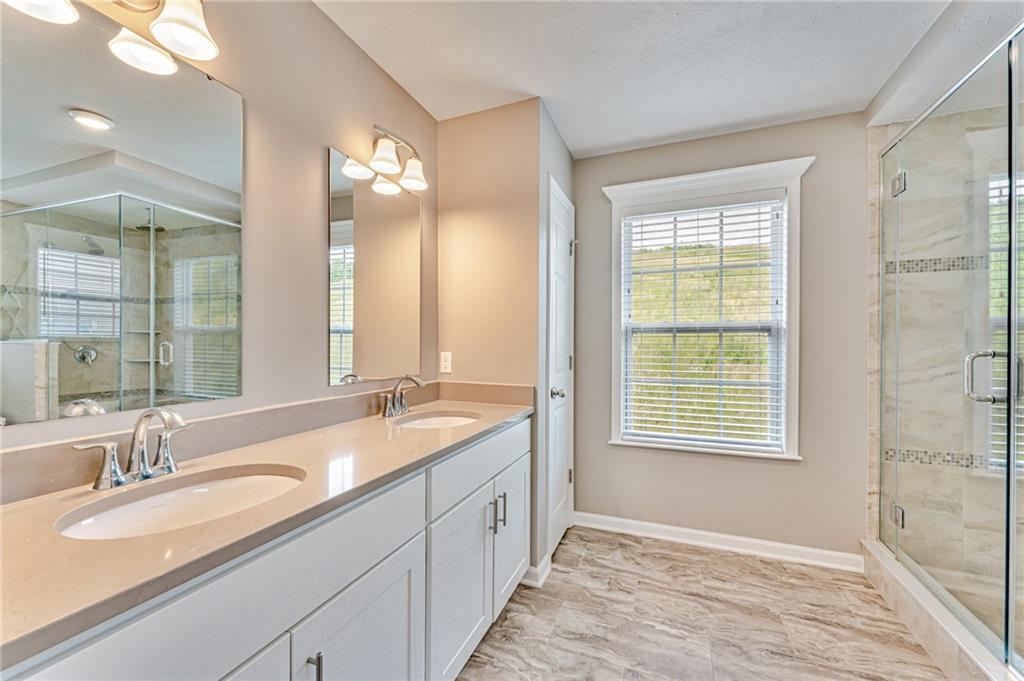 331 Trinity Way Wexford, PA 15090 - Photo 34 of 50 a bathroom with a granite countertop sink mirror and a bathtub