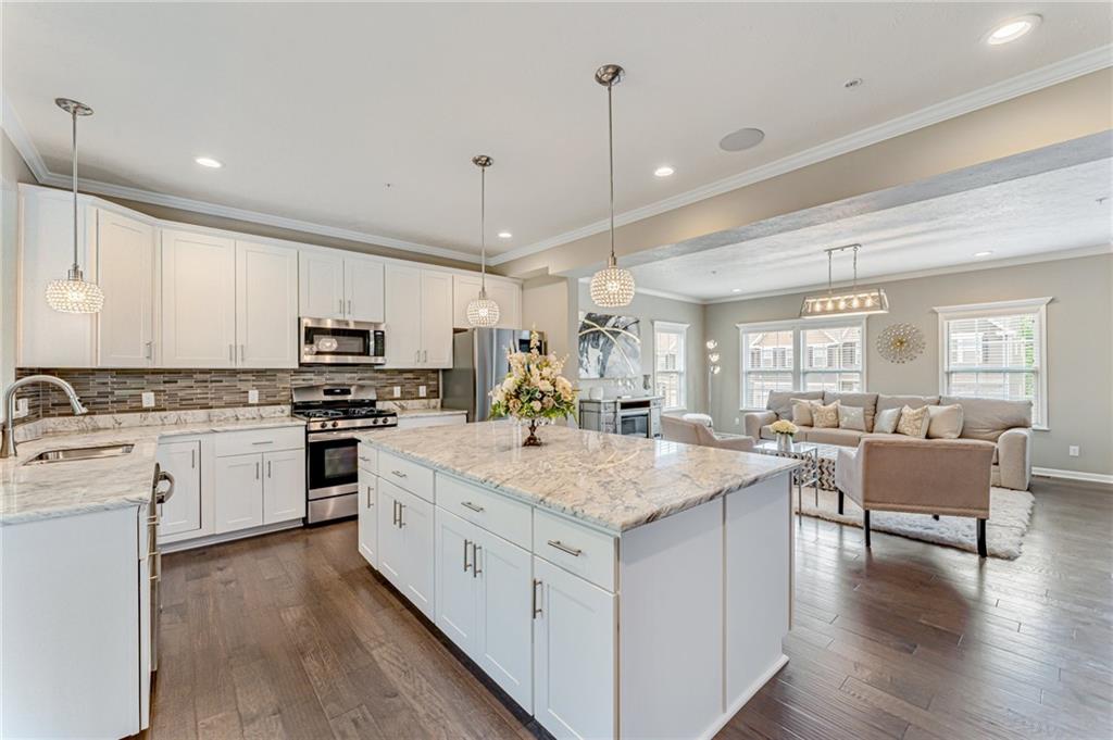 331 Trinity Way Wexford, PA 15090 - Photo 4 of 50 a large white kitchen with kitchen island a sink table and chairs