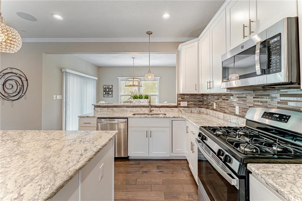 331 Trinity Way Wexford, PA 15090 - Photo 7 of 50 a kitchen with a stove and a sink