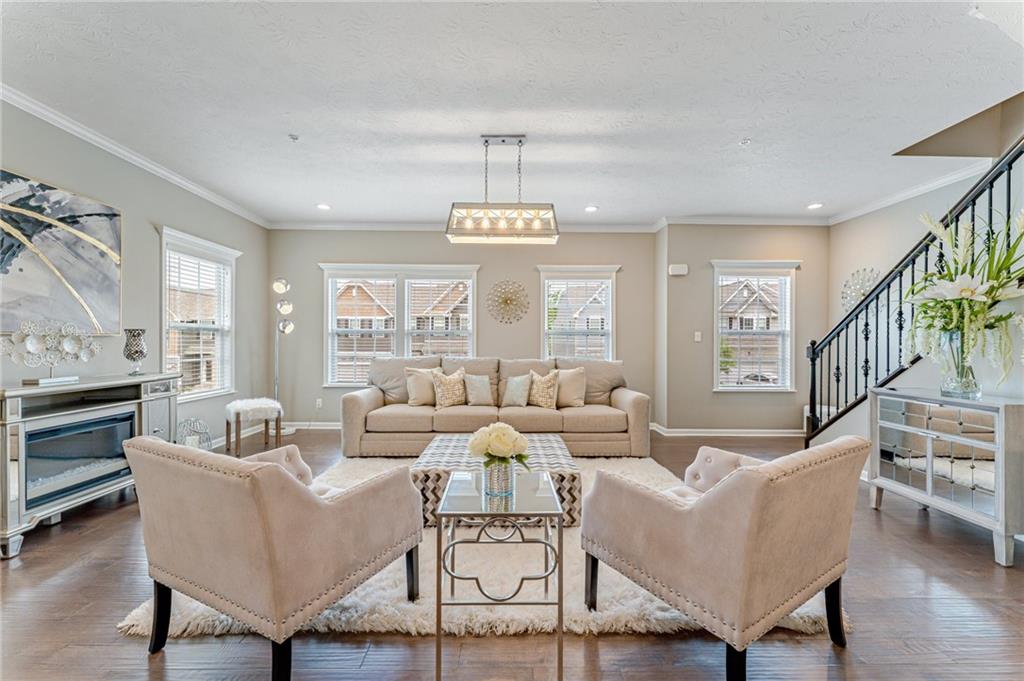 331 Trinity Way Wexford, PA 15090 - Photo 9 of 50 a living room with furniture dining table and a chandelier