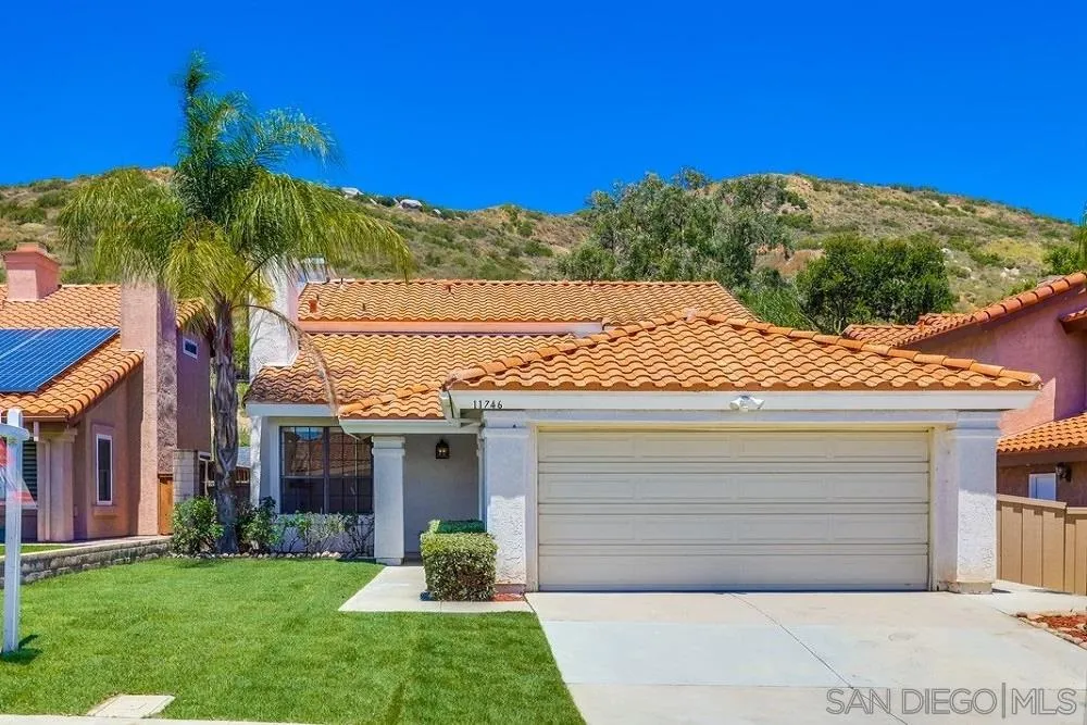 11746 Springside Road San Diego, CA 92128 - Photo 1 of 25 a front view of a house with a garden and yard